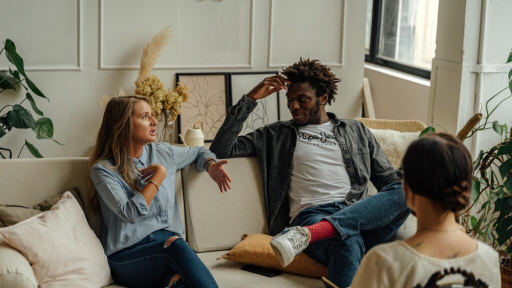 Couple discussing with each other in counselling